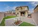 Beautiful backyard featuring artificial grass, a fire pit, and a covered patio area at 7109 Red Gulch St, North Las Vegas, NV 89084