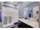 Bright bathroom featuring a glass-enclosed shower, blue towels, and decorative accents at 7109 Red Gulch St, North Las Vegas, NV 89084