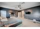 Well-lit bedroom featuring dark gray walls, carpet, and a large dresser with mirror at 7109 Red Gulch St, North Las Vegas, NV 89084