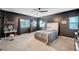 Stylish bedroom with dark gray walls, carpet, ceiling fan, and lots of natural light at 7109 Red Gulch St, North Las Vegas, NV 89084