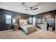 Spacious bedroom with neutral carpet, dark walls, ceiling fan and ample light at 7109 Red Gulch St, North Las Vegas, NV 89084