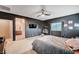 Stylish bedroom featuring dark gray walls, ceiling fan, carpet, and a vanity area at 7109 Red Gulch St, North Las Vegas, NV 89084