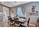 Cozy dining area with a wooden table and decorative accents near the sliding glass door at 7109 Red Gulch St, North Las Vegas, NV 89084