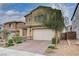 Charming two-story home with a paved driveway, complemented by manicured landscaping and a neutral color scheme at 7109 Red Gulch St, North Las Vegas, NV 89084