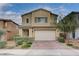 Charming two-story home with a paved driveway, complemented by manicured landscaping and a neutral color scheme at 7109 Red Gulch St, North Las Vegas, NV 89084