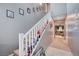 Inviting hallway with staircase and neutral tones that leads into a cozy living space at 7109 Red Gulch St, North Las Vegas, NV 89084