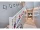 Hallway with carpeted stairs, neutral colors, and a view into the living room at 7109 Red Gulch St, North Las Vegas, NV 89084