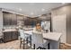 Bright, eat-in kitchen features a breakfast bar, tile backsplash, stainless appliances and dark cabinets at 7109 Red Gulch St, North Las Vegas, NV 89084