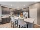 Stylish kitchen featuring a large island with seating, stainless steel appliances, and modern cabinetry at 7109 Red Gulch St, North Las Vegas, NV 89084