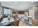 Bright, eat-in kitchen features a breakfast bar, tile backsplash, stainless appliances and dark cabinets at 7109 Red Gulch St, North Las Vegas, NV 89084