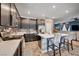 Open concept kitchen with stainless steel appliances and a breakfast bar at 7109 Red Gulch St, North Las Vegas, NV 89084