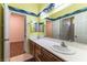 Bathroom boasts a long vanity with dual sinks, ample counter space, and decorative wall art at 7549 Evening Falls Dr Dr, Las Vegas, NV 89131