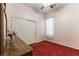 This bedroom features pink walls, red carpet, a sliding door closet and natural light at 7549 Evening Falls Dr Dr, Las Vegas, NV 89131