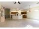 A spacious kitchen with an island, ample cabinetry and tile flooring extending into the living area at 7549 Evening Falls Dr Dr, Las Vegas, NV 89131