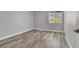 A bedroom featuring neutral paint, wood flooring and a window at 8500 Gull Dr, Las Vegas, NV 89134
