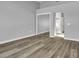 This bedroom has wood flooring, neutral paint and large mirrored closet at 8500 Gull Dr, Las Vegas, NV 89134