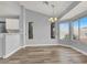 Bright dining area with modern light fixture and large windows providing outdoor views at 8500 Gull Dr, Las Vegas, NV 89134