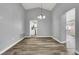 Open dining room with vaulted ceiling and wood-style floors, next to kitchen at 8500 Gull Dr, Las Vegas, NV 89134
