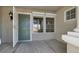 Inviting entryway with a green front door, large windows, and neutral stucco walls at 8500 Gull Dr, Las Vegas, NV 89134