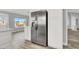 Kitchen featuring stainless steel refrigerator and view to the backyard at 8500 Gull Dr, Las Vegas, NV 89134