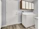 Bright laundry room with cabinets and modern white washer and dryer at 8500 Gull Dr, Las Vegas, NV 89134