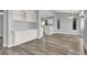 Spacious living area featuring built-in cabinets, wood-style flooring, and gray color scheme at 8500 Gull Dr, Las Vegas, NV 89134