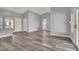 Bright living space with wood-style floors, vaulted ceiling, and neutral gray paint at 8500 Gull Dr, Las Vegas, NV 89134