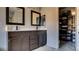 Bathroom features a double sink vanity with dark cabinets and large framed mirrors at 8532 Caddy Corner St, Las Vegas, NV 89139