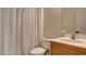 Cozy bathroom featuring a shower and tub combo behind a white curtain and a single sink at 8532 Caddy Corner St, Las Vegas, NV 89139