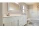 Clean bathroom featuring a white vanity with a large mirror, a window, and a tub and shower combo at 8532 Caddy Corner St, Las Vegas, NV 89139