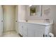 Clean bathroom featuring a white vanity, framed mirror, and tiled floors, toilet, and towel rack at 8532 Caddy Corner St, Las Vegas, NV 89139