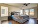 Spacious bedroom featuring a large bed, dark wood floors, and plenty of natural light at 8532 Caddy Corner St, Las Vegas, NV 89139