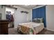 Quaint bedroom featuring closet, blue curtains, and a bed with decorative pillows and floral comforter at 8532 Caddy Corner St, Las Vegas, NV 89139