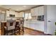 Stylish kitchen featuring white cabinetry, modern appliances, and a breakfast bar at 8532 Caddy Corner St, Las Vegas, NV 89139
