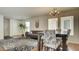 Inviting living room featuring a gray sofa, floral rug, and dining area with floral chairs at 8532 Caddy Corner St, Las Vegas, NV 89139