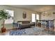 Comfortable living room with a gray sofa, decorative rug, and dining table set at 8532 Caddy Corner St, Las Vegas, NV 89139