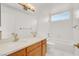 Bright bathroom features a double sink vanity, tub-shower combo and window at 8600 Soneto Ln, Las Vegas, NV 89117