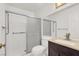 Bathroom featuring tiled shower with sliding glass door, dark cabinets, and toilet at 8600 Soneto Ln, Las Vegas, NV 89117