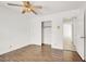 Bedroom with hardwood floors, ceiling fan, closet, and an open doorway at 8600 Soneto Ln, Las Vegas, NV 89117