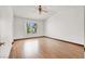 Bedroom with wood look floors, ceiling fan, and window at 8600 Soneto Ln, Las Vegas, NV 89117