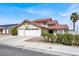 Charming two-story home with a well-maintained lawn and a spacious two-car garage at 8600 Soneto Ln, Las Vegas, NV 89117