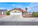 Inviting two-story home featuring a red tile roof and a spacious two-car garage at 8600 Soneto Ln, Las Vegas, NV 89117