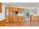 Updated kitchen featuring wooden cabinets, quartz countertops, modern backsplash, and tile floors at 8600 Soneto Ln, Las Vegas, NV 89117
