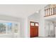 Bright, airy living room with white walls, marble floors, and a grand double-door entryway at 8600 Soneto Ln, Las Vegas, NV 89117