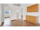 Open living room featuring hardwood floors, built in cabinets, and an open doorway at 8600 Soneto Ln, Las Vegas, NV 89117