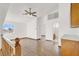 Open living room with hardwood floors and staircase, complemented by natural light at 8600 Soneto Ln, Las Vegas, NV 89117