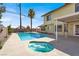 Backyard swimming pool and jacuzzi surrounded by concrete decking at 8600 Soneto Ln, Las Vegas, NV 89117