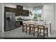 Modern kitchen features stainless steel appliances, a center island with bar stool seating, and dark wood cabinets at 890 Apatite Pl # Lot 68, Henderson, NV 89011