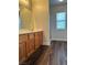 Bathroom vanity with mirror and wood cabinets. A shower is visible at 9078 Camp Light Ave # 102, Las Vegas, NV 89149