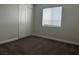 This is a cozy carpeted bedroom with a large window and a spacious closet at 9078 Camp Light Ave # 102, Las Vegas, NV 89149